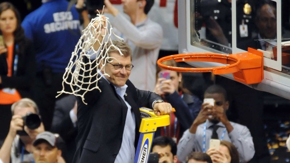 Connecticut head coach Geno Auriemma cuts the nets after his NCAA record-breaking (men's and women's) 11th national basketball title. Photo © Lee Michaelson, all rights reserved.
