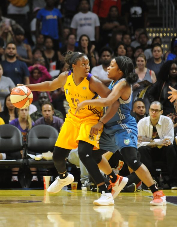 Chelsea Gray of the Los Angeles Sparks dribbles past Jia Perkins of the Minnesota Lynx. Photo © Lee Michealson.