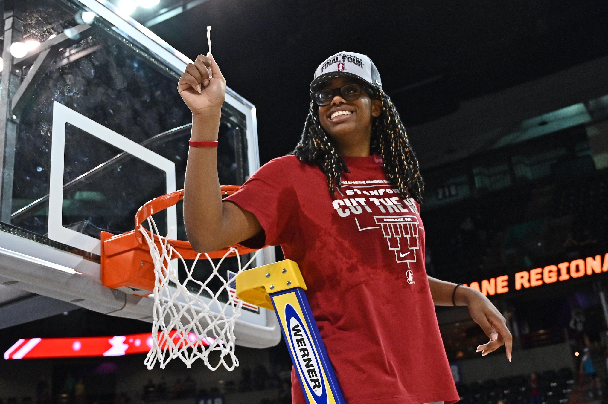 Mar 27, 2022; Spokane, WA, USA; Stanford Cardinal forward Francesca Belibi (5) holds a piece of the net after a game against the Texas Longhorns in the Spokane regional finals. Credit: James Snook-USA TODAY Sports.