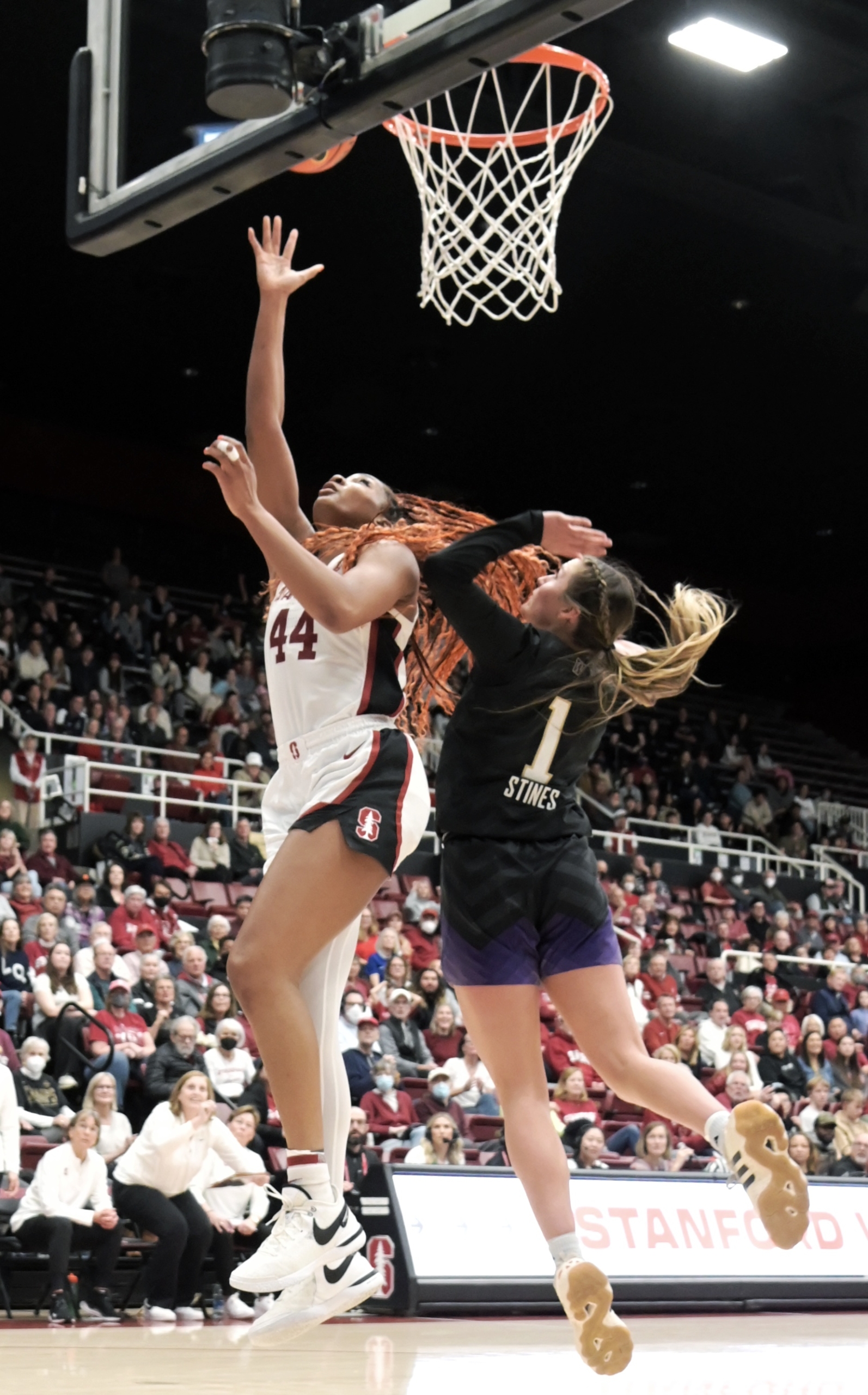 Jan. 7, 2024 - Stanford, Calif. - Stanford's Kiki Iriafen and Washington's Hannah Stines under the basket. Photo © Baranduin Briggs, all rights reserved.